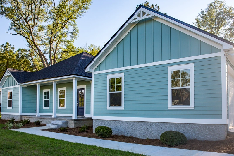 beautiful home with white and blue vinyl siding colors after fresh paint