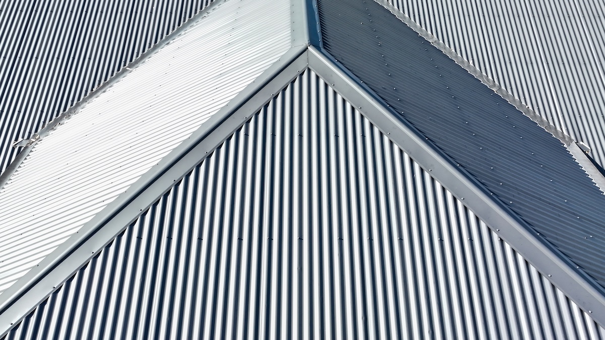 standing seam vs corrugated metal roof Drone aerial photograph of a grey coated corrugated iron roof on a domestic residence