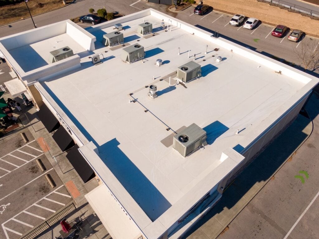 commercial roof warranty Sunny Day Time Drone Images of a TPO Roof on a Commercial Building.