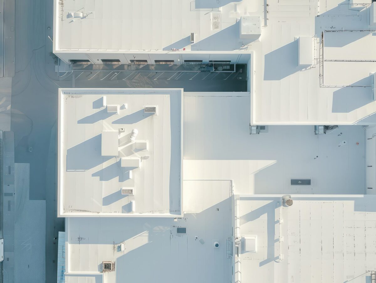 single ply Seamless white PVC commercial flat roof of factory, summer day. Aerial high view. Generative AI.