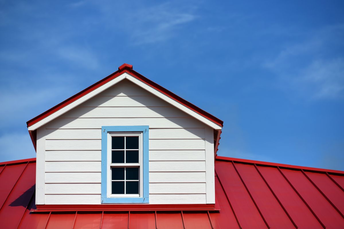 metal roof accents red and white house blue sky