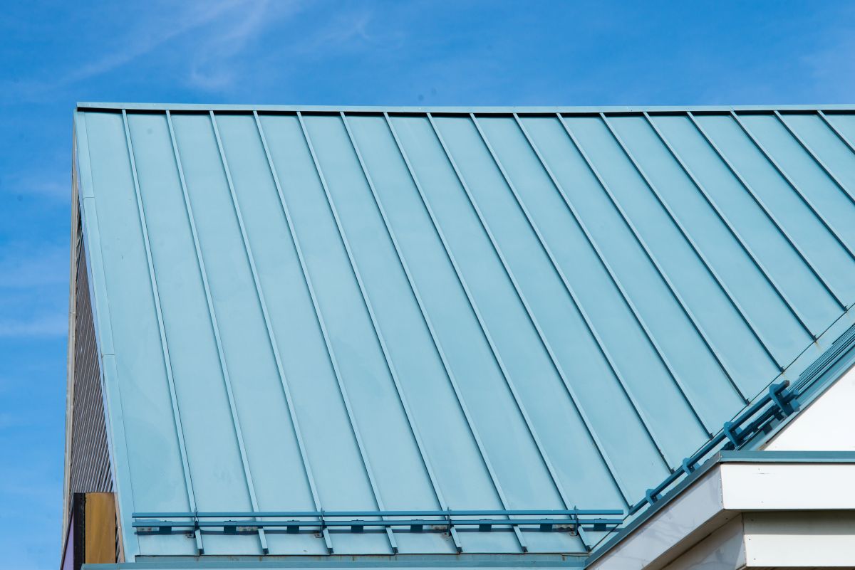 metal roof accents white wall blue sky snow guards