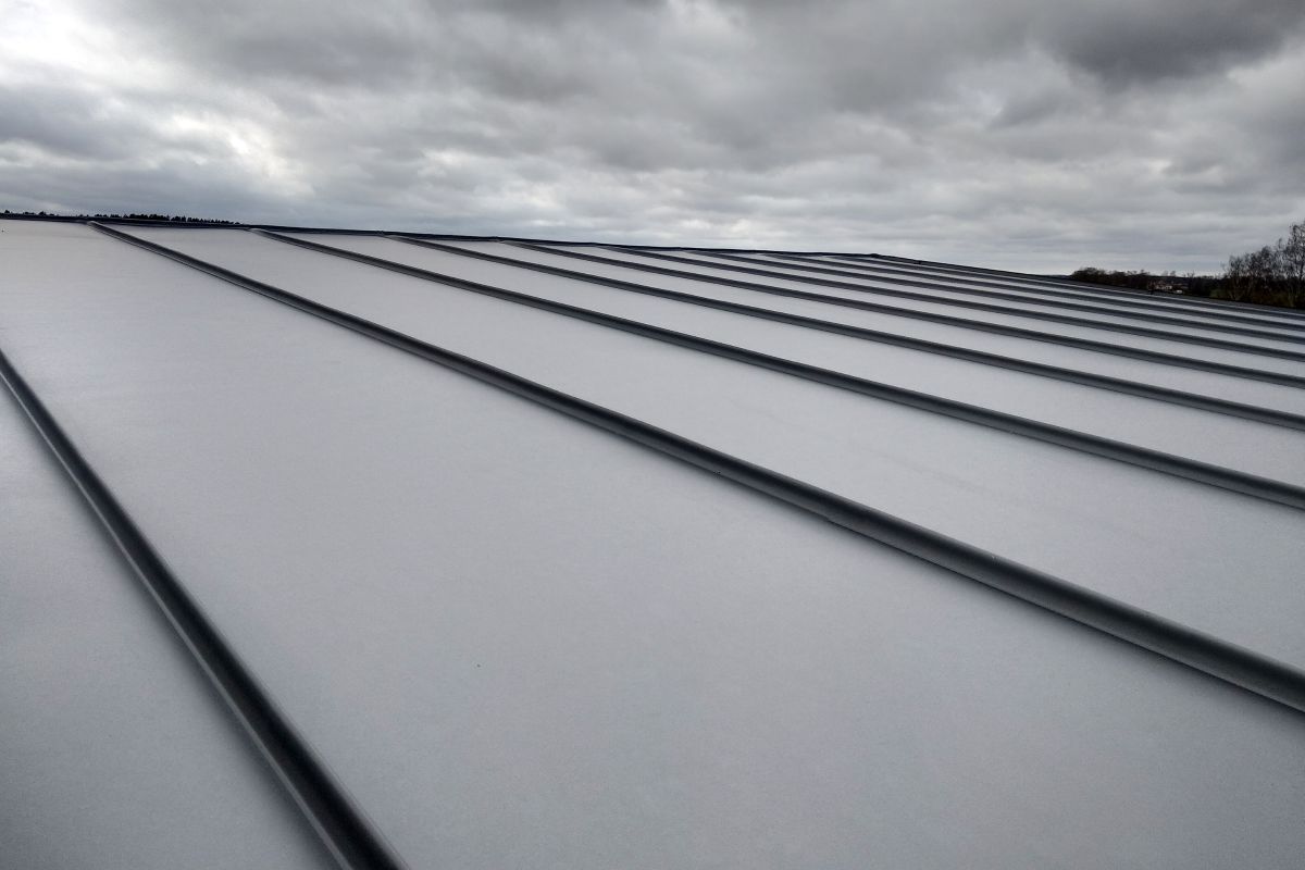 Close-up detail of house roof made from gray metal sheets