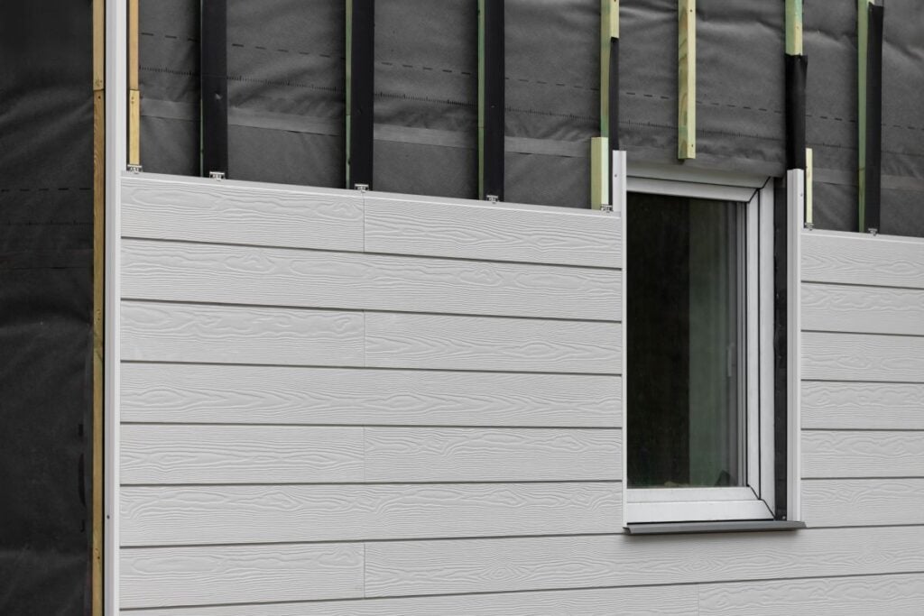 wood texture composite siding being installed