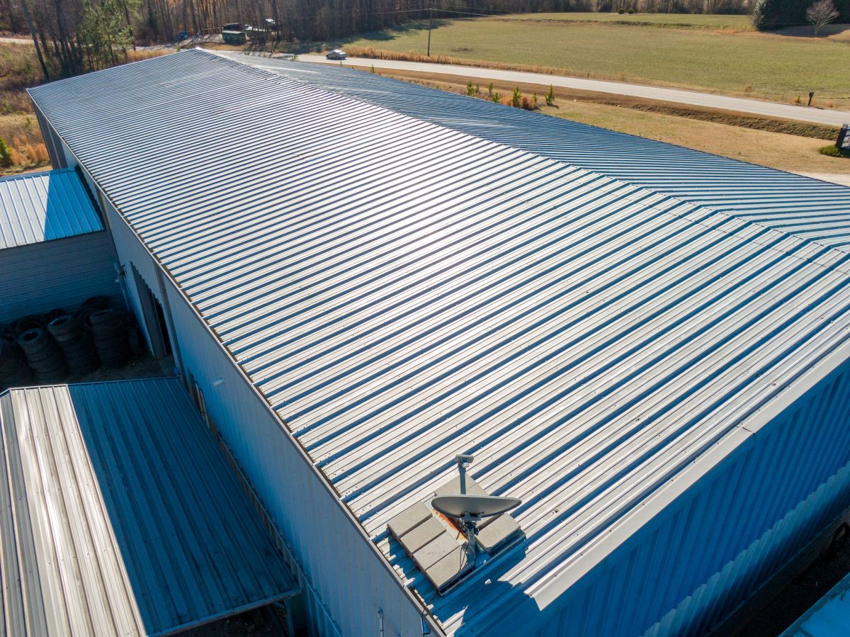 High Resolution Aerial Drone View of Gray Standing Seam Metal Roof On Commercial Building