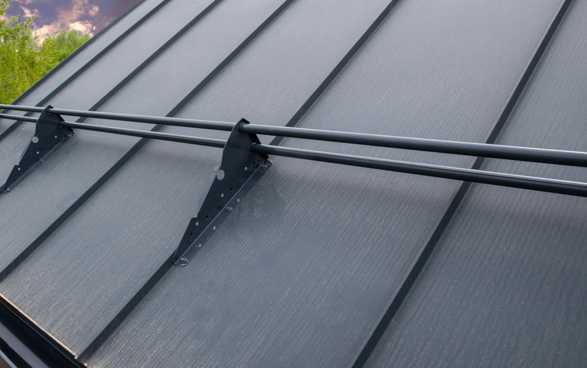 Snow rails are installed on gray seam roof
