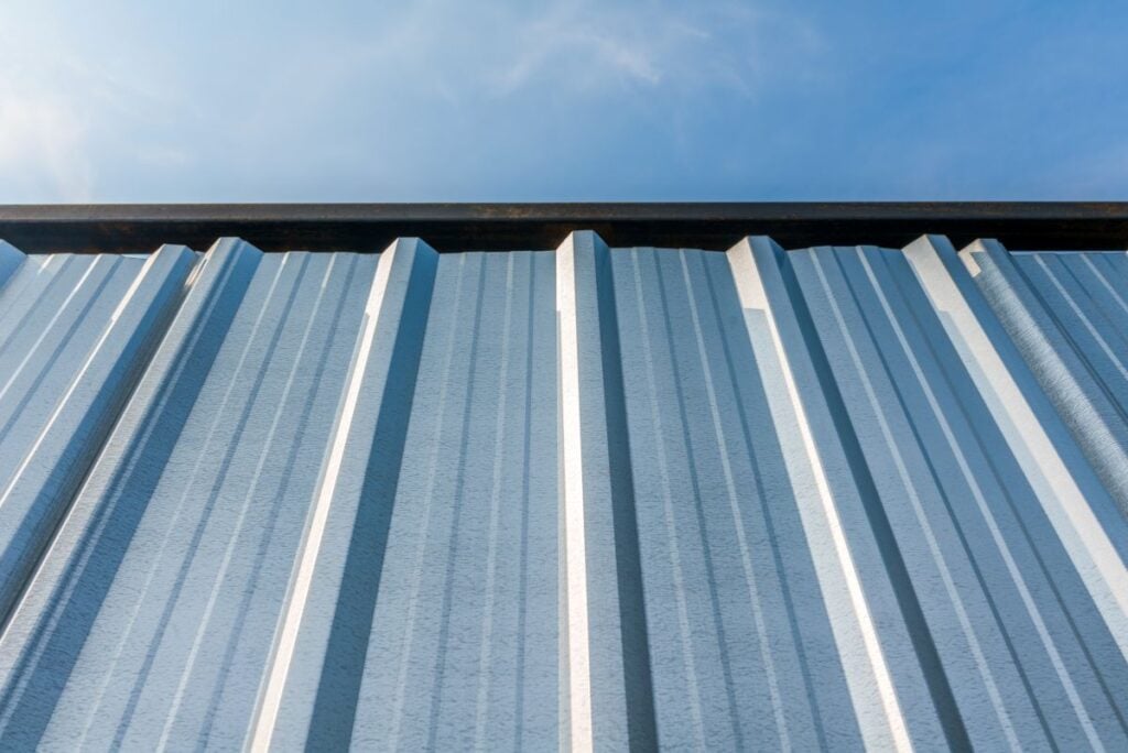 galvanized sheet metal roof against a blue sky
